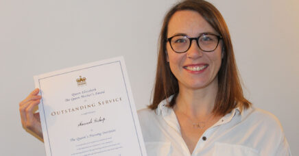 ANP Hannah Bishop holding up her QNI award certificate