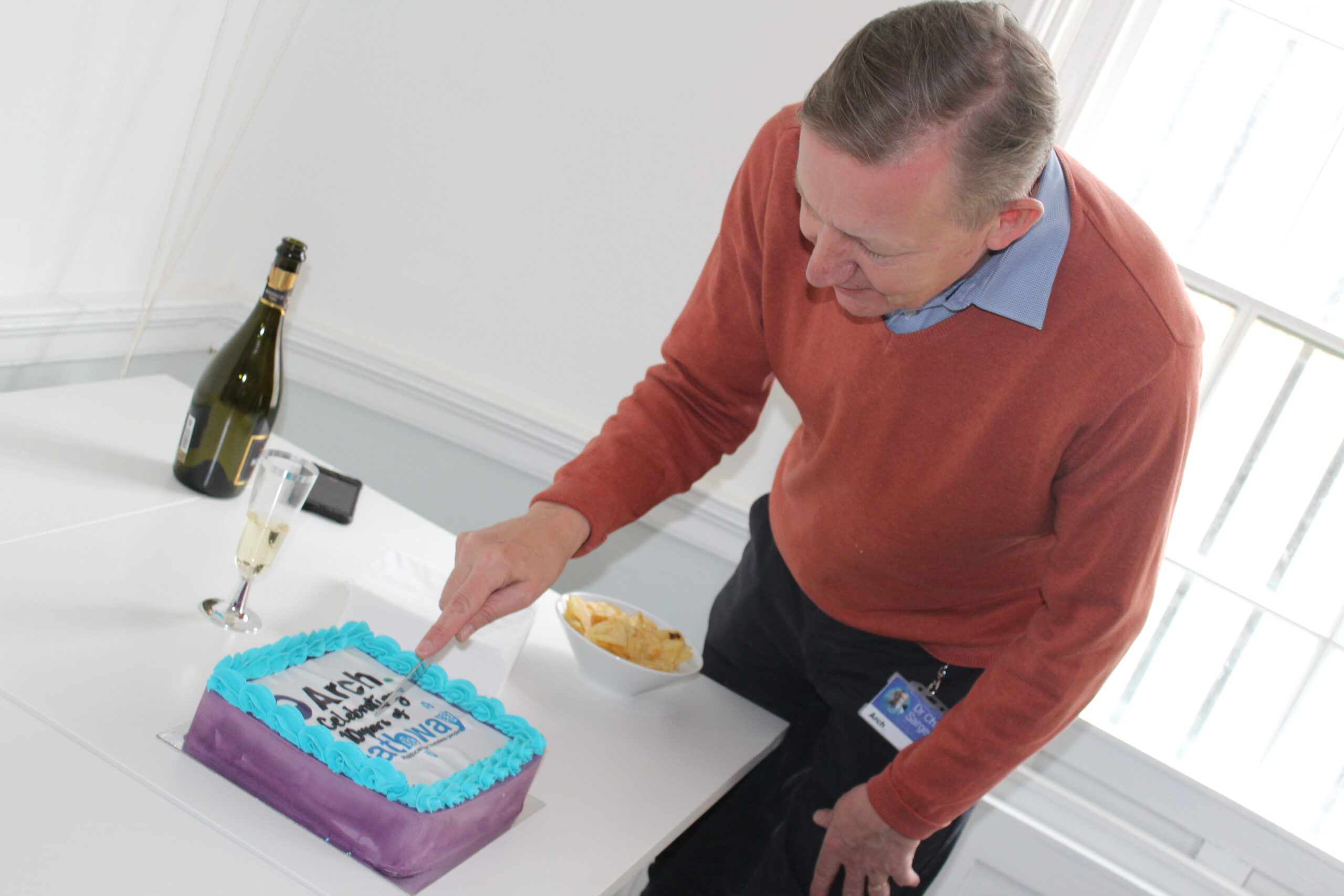 Pathway clinical lead Dr Chris Sargeant cuts the cake to celebrate 10 years of Pathway in Brighton