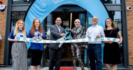 Arch and others cutting a ribbon for the new coop store launch