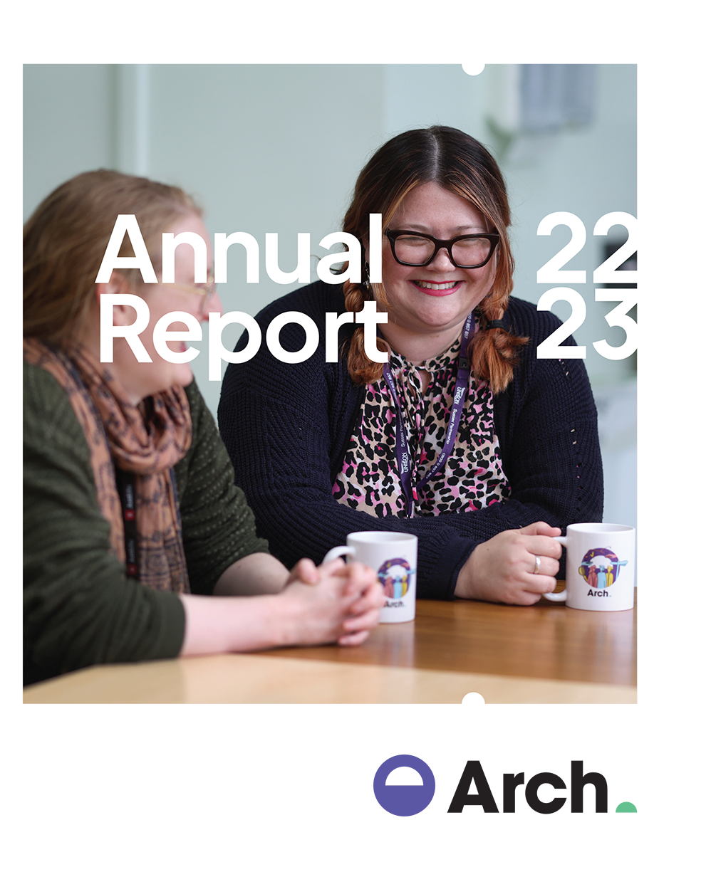 Front cover of Arch's 2022-2023 annual report showing a picture of two Arch colleagues smiling over a cup of tea.