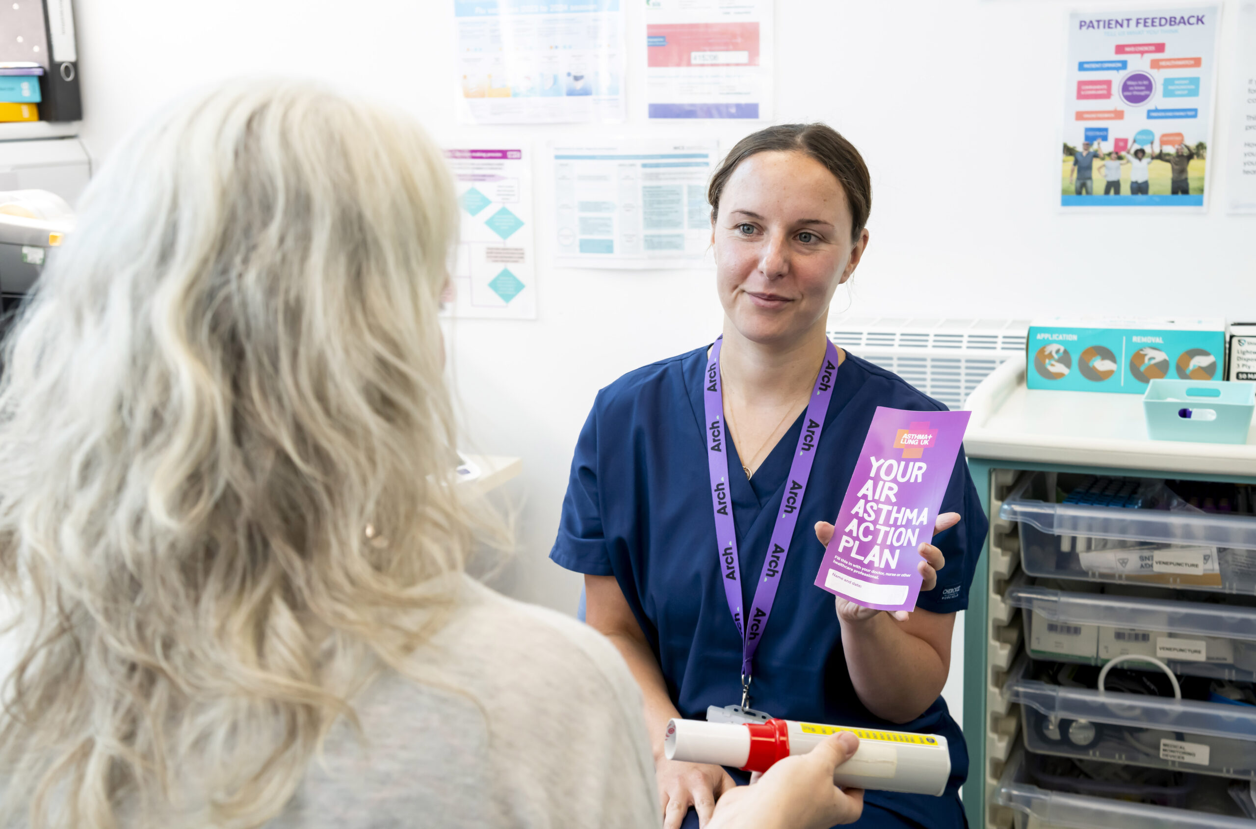 A nurse at Arch talks a patient through a leaflet about respiratory health.